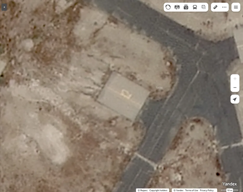 Yandex Maps satellite imagery showing a number that reads as 12 on the northeastern helipad